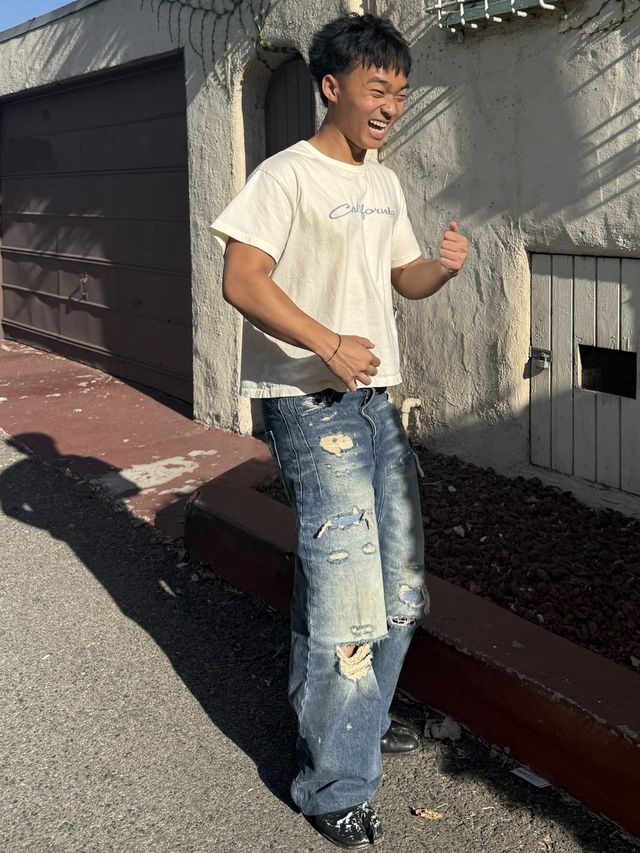 Gerald laughing on a sunny sidewalk